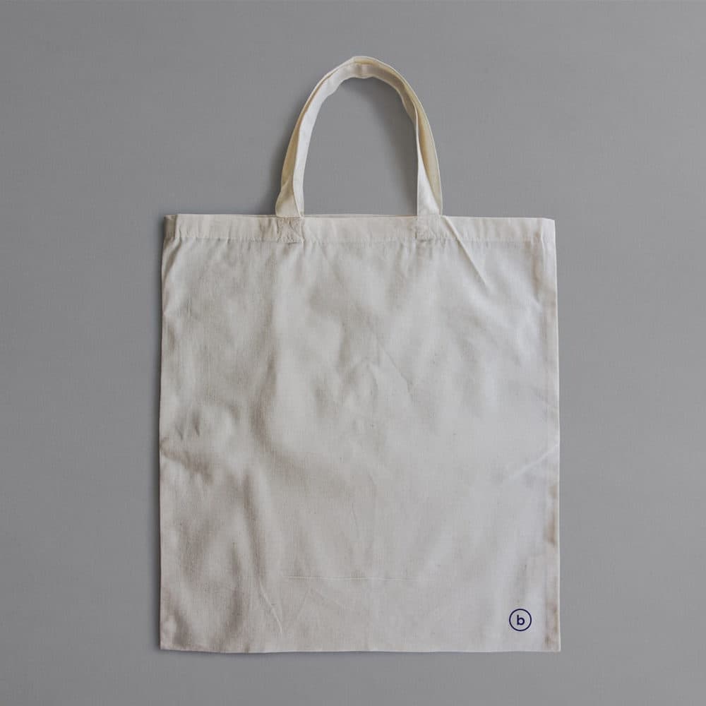 A blank tote on a grey ground