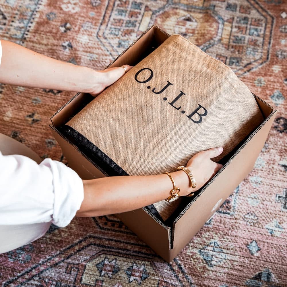 Hands opening a branded box