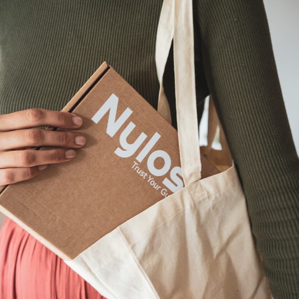 Someone carrying a branded tote and bag
