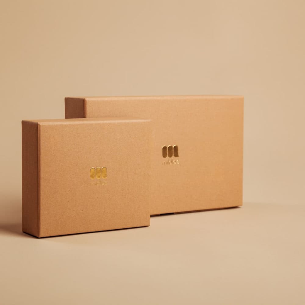 Plain board cartons on a tan ground