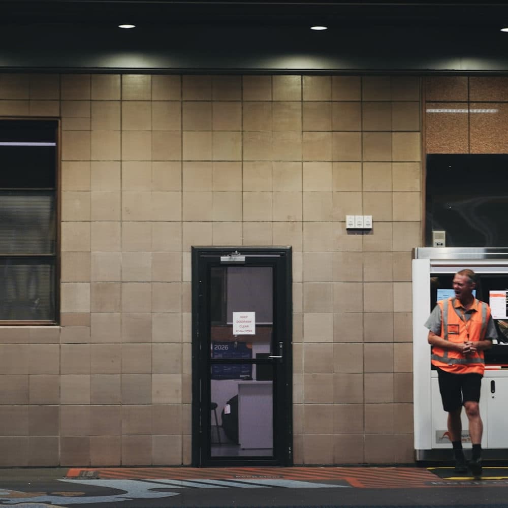 Worker in an orange vest at night